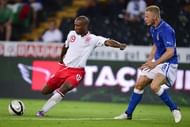 England's forward Jermain Defoe (L) kicks the ball next to Italian defender Ignazio Abate to score